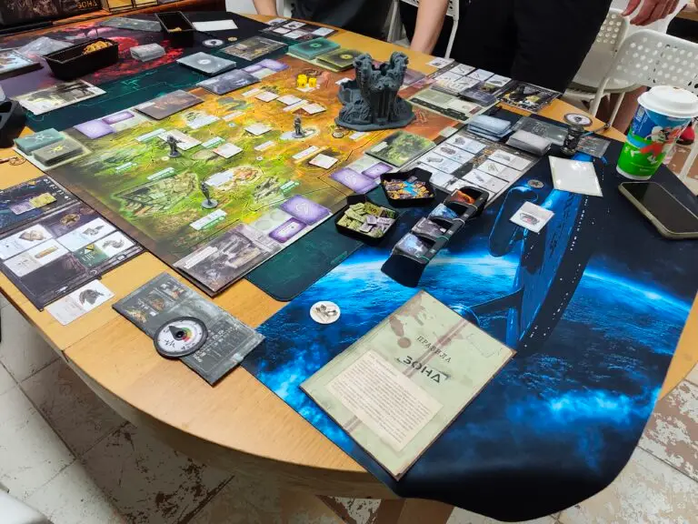 Full table setup of Zona: The Secret of Chernobyl — board, cards, money and rulebook
